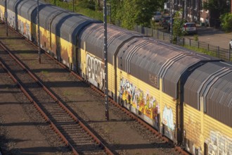 Colourfully painted goods train with freight wagons from a bird's eye view, Bremen, Germany