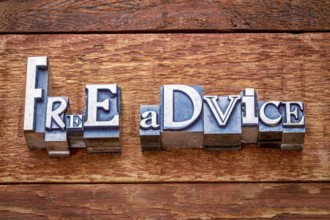 Free advise word abstract in letterpress metal type against rustic barn wood