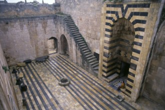 The Citadel of Aleppo is a large medieval fortified palace in the centre of the old city of Aleppo,