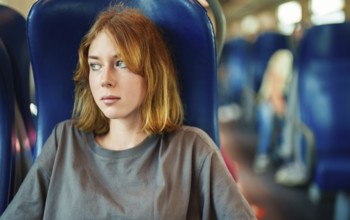 Teenage girl travelling inside the train