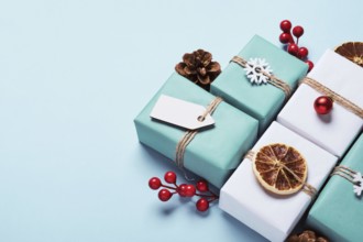 Gifts boxes set packed in paper, decorated with baubles and twine. Eco Christmas decor