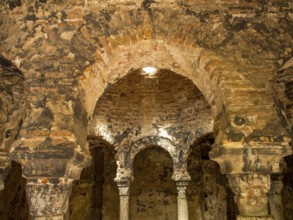 Historic interior architecture with arches and stone walls in warm light, palma de Majorca,