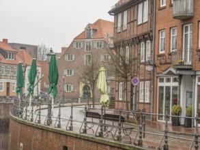 Street scene with brick buildings and closed green sunshades in a quiet atmosphere, stade, germany