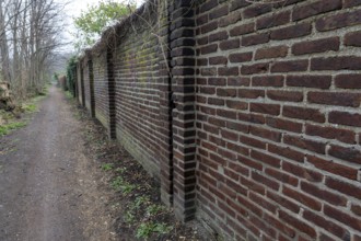 Brick wall between street and od industrial area