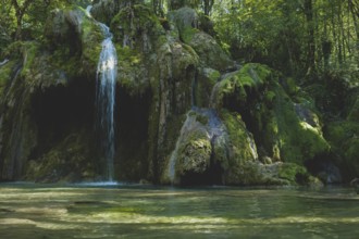 The tufa waterfall near Arbois. Crystal clear waterfall, powerful waterfall