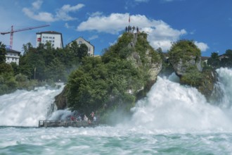 Tourist platform directly above very wild water of the Rhine waterfalls at Schaffhausen,