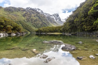 Tranquil mountain lake Mackenzie at the famous Routeburn Track, Fiordland National Park, South