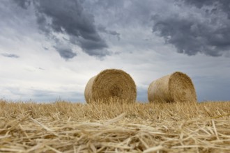 Straw bales on farmland Storm clouds