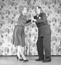 Learning to dance in the 1940s. A couple is dancing together. An instructiv image on how to