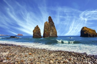 Three huge scenic rocks near the pebble beach. Concept of exotic and ecological tourism. Volcanic