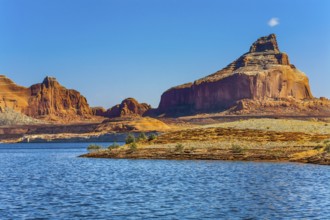 Huge picturesque lake with blue water, among outcrops of red sandstone. Lake Powell is a reservoir