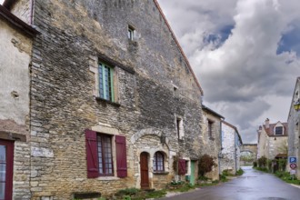 Street in Chateauneuf commune with historical stone houses, France
