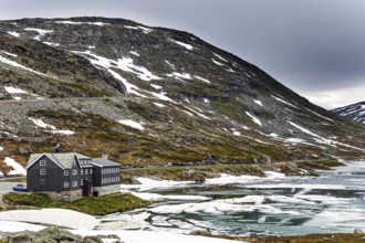 Semi-frozen lake Djupvatnet in the mountains of Northern Norway. Summer trip to Norway. Cold July