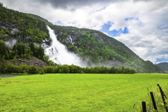 Norway. Huge powerful cascading waterfal Vidfossen. Scenic road in the mountains of Western Norway.