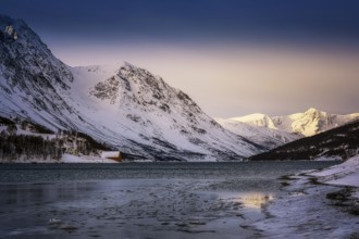 Beautiful winter landscape scene mountain in background in Northern Norway. sunset or sunrise in