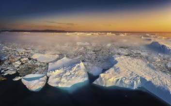 Floating glaciers in the rays of the setting sun during a polar night