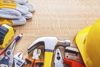 Organized copyspace set tools helmet wrench nippers pliers hammer cutter tapeline gloves on wooden