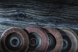 Rotary sanding discs on wooden board