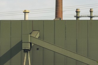 Detailed view of an industrial building with high voltage power lines