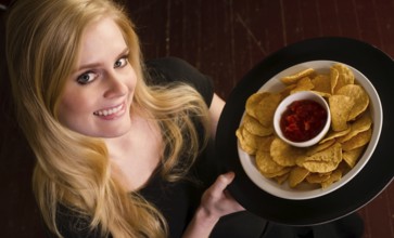 Vibrant service professional brings the servings