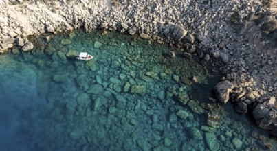 Drone aerial seascape with luxury yacht moored on the coast. Blue water Summer vacations in the sea