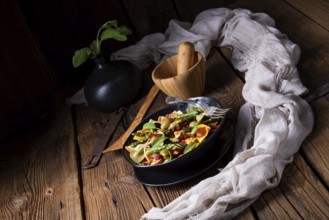Pasta salad with green asparagus, olives and Parma ham