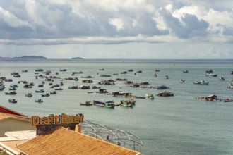 Calm sea with scattered boats and a cloudy sky in a coastal setting, palms, city, sun city, Phu