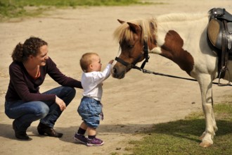 Mother with toddler and pony