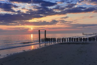 Beautiful Sunset at the seaside in the Netherlands with pastel colours in the clouds and the water