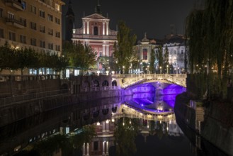 Famous three bridges at the Preseren square in the center of Ljubljana colorfully illuminated at