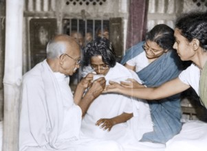 Mahatma Gandhi with Amtus Salam drinking juice breaking fast, Bangladesh, Asia, January 20, 1947