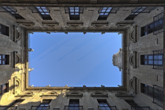 A courtyard in the Royal Tobacco Factory of Seville photographed from below. The bird protection