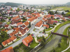 Drone stills of a small town in the countryside in autumn. River running trough the town, aerial