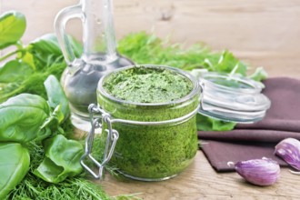 Sauce of dill, parsley, basil, cilantro, other spicy herbs, garlic and vegetable oil in a glass