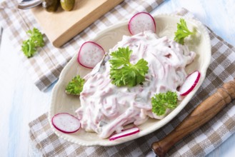 Delicious homemade meat salad with mayonnaise and cucumber