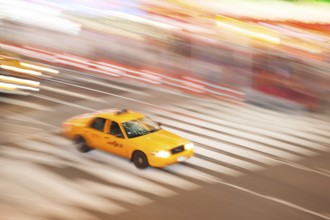Panning image of a Yellow Taxi cab in Times Square, New York City. New York. USA
