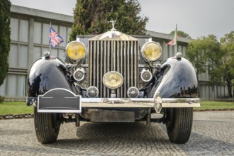 Lisbon, Portugal - Oct 15, 2023: Front view of Rolls-Royce Phantom III parked in cobblestone