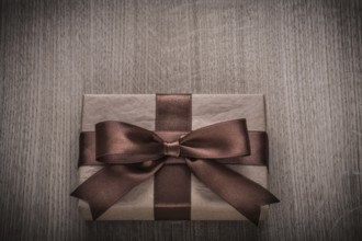 Wrapped vintage present box with tied brown bow celebration concept
