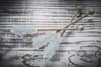 Sweet sugar sticks on vintage wooden board