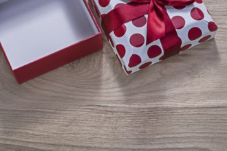 Red opened gift box on wooden board horizontal version celebrations concept