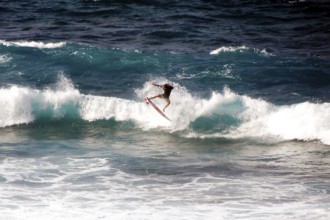 Surfer riding a wave in Hookipa Beach, Maui, Hawaii