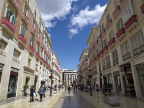 Lively shopping street with lots of people, shops and beautiful architecture, malaga, spain