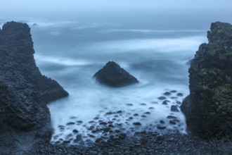 Stormy coastal landscape of Arnarstapi at night, Iceland