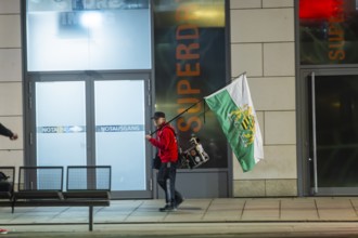 A supporter of the radical Free Saxons, walks with a Saxon flag and drum on Wilsdruffer Straße for