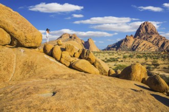 Travel to Africa. Woman photographs of a beautiful landscape. Picturesque stones in the Spitskoppe