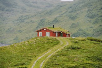 Hut wooden mountain huts in mountain pass Norway. Norwegian landscape with typical scandinavian