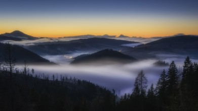 Fog over the Liptov village of Velke Borove before sunrise by Liptovska Mara in Slovakia