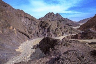 Walking road to the Pillars of Amram. Multi-colored mountains of Eilat, Israel. Warm day in January