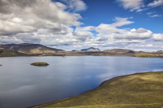 Rhyolitic mountains surround the volcanic lake. Summer travel to Iceland