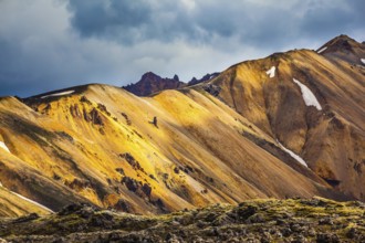 Multicolored rhyolite mountains scenic highlights the July sun. Travel to Iceland in the summer